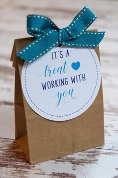 it's a great working with you gift card in a brown paper bag on a wooden table