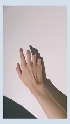 two hands reaching up towards each other with one hand holding the other's finger