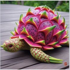 a pink and green turtle statue sitting on top of a wooden table