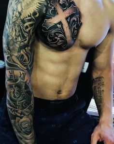 a man with a cross tattoo on his chest and arm is posing for the camera