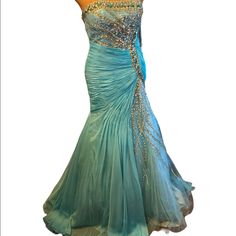 a dress is displayed on a mannequin with blue and gold beads in it