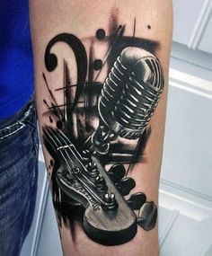 a man with a guitar tattoo on his arm