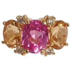 18kt White Gold Mini Three Stone GUM DROP™ Ring with Pink Topaz and Light Citrine and diamonds ~0.40cts A big bang in a small package! The ring measures 7/8" across the curved top and 3/4"from end stone to end stone. The ring can be sized. The GUM DROP™ Ring Collection comes in four sizes of stones and can be made in any stone combination in either 18kt White Gold or 18kt Yellow Gold. Please contact me with any inquiries you may have. Best, Christina Three Stone Emerald Cut Ring, Chocolate Diamond Earrings, Topaz And Citrine, Gum Drop, Funky Rings, Topaz Yellow, Emerald Wedding Rings, Fun Bracelet, Emerald Cut Rings