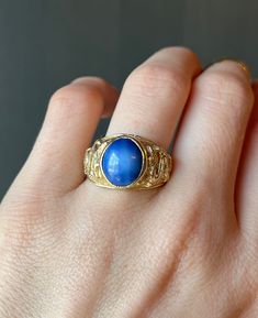 "* Vintage late 1900's - early 2000's solid 14 carat yellow gold dragon ring, set with a beautiful blue star sapphire.  * Stamped lightly on the inside of the band \"14K\", and \"AVC\" * Measurements:   Star Sapphire Cabochon- Approx. 12mm x 10mm x 5mm  * Weight- 9.6 grams Please view and inspect the photos closely, as they are considered part of the condition. I endeavor to fully disclose all condition information clearly, however, please note that what qualifies as excellent condition for historical jewelry / collectibles differs from modern and contemporary pieces. Minor age wear is typical and to be expected for antique and vintage jewelry. All items are unpolished and in their vintage condition, items can easily be polished up if so desired.     Enjoy,  Dev" Blue Cabochon Sapphire Ring In 14k Gold, Vintage 14k Gold Moonstone Ring, Vintage 14k Yellow Gold Moonstone Ring, Vintage Gold Sapphire Cabochon Ring, Vintage Yellow Gold Moonstone Ring Collectible, Gold Vintage Sapphire Cabochon Ring, Vintage Gold Sapphire Ring With Cabochon, Celestial Style Cabochon Yellow Gold Rings, Classic Blue Moonstone Ring For Formal Occasions