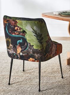 an upholstered chair sits in front of a table