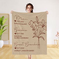 a woman is holding up a towel with the names of her wedding dates on it