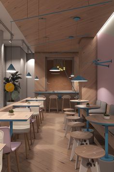 the interior of a restaurant with wooden tables and chairs in pastel colors on the walls