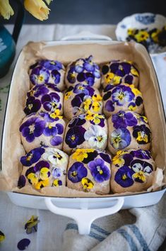 a pan filled with lots of purple and yellow flowers