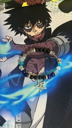 an anime character with black hair and blue eyes is wearing a bracelet that has charms on it