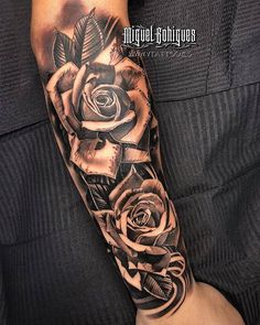 a black and white rose tattoo on the arm