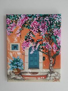 a painting of a blue door and pink flowers on an orange wall with a potted tree