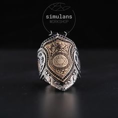 This uniquely designed Mystic Solomon Seal Sterling Silver Zihgir Ring showcases intricate craftsmanship and timeless elegance. The ring is meticulously handcrafted from 925 sterling silver, featuring an intricate Solomon Seal engraved on the top. This powerful symbol is believed to command metaphysical entities, providing protection and strength to the wearer. The sides of the ring are adorned with ornate motifs, enhancing its mystical allure. Perfect for those who seek a blend of ancient symbo Spiritual Sterling Silver Signet Ring Stamped 925, Silver Sterling Engraved Ring, Spiritual Style, Archery Thumb Ring, Luxury Black Spiritual Signet Ring, Silver Spiritual Signet Ring With Polished Finish, Spiritual Sterling Silver Hallmarked Signet Ring, Solomons Seal, Thumb Rings, Ancient Wisdom