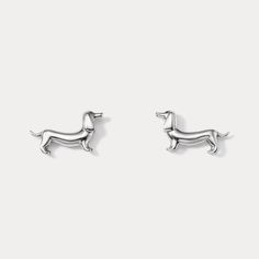 silver dachshund stud earrings on a white background