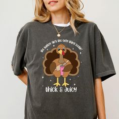 Get a laugh this Thanksgiving with our Comfort Colors Thanksgiving Shirt featuring the hilarious phrase "The Turkey Ain't the Only Thing Lookin' Thick and Juicy." Perfect for adding some humor to your holiday gatherings, this shirt is great for anyone who loves a playful take on Thanksgiving. The soft and cozy Comfort Colors fabric makes it ideal for staying comfortable while enjoying the holiday feast, and it's a great gift idea for those who enjoy a good laugh during the fall season. ✨ This sh Stuffed Turkey Shirt, Funny Turkey, Turkey Shirts, Holiday Feast, Thanksgiving Shirt, Fall Gifts, Thanksgiving Shirts, Holiday Gathering, Comforters Cozy