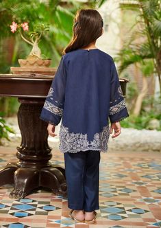 2-Piece Embroidered Suit for Girls (shirt & trouser only). Description Intricately crafted two-piece design with elegant beaded and embroidered details with a hint of mirror embellishment. Lining included. Fabric is paper cotton. Color is Navy Blue Traditional Blue Pant Set With Floral Embroidery, Traditional Blue Sets With Embroidered Sleeves, Festive Cotton Sets With Embroidered Sleeves, Elegant Blue Pant Set With Resham Embroidery, Blue Embroidered Long Sleeve Pant Set, Elegant Blue Embroidered Pant Set, Traditional Cotton Salwar Kameez With Embroidered Sleeves, Fitted Blue Pant Set With Resham Embroidery, Elegant Blue Sets With Embroidered Border