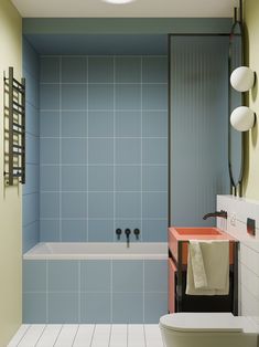 a bathroom with blue and white tiles on the walls, floor, and bathtub