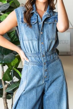 Step into effortless style with the Devin Denim Jumpsuit, featuring a medium-washed denim finish and a chic, sleeveless design. The button-down front and collared neck add a touch of sophistication, while the big cargo chest pocket and back pockets offer practical flair. With a ruched waist back and extra-wide pant legs, this jumpsuit combines comfort and fashion for a versatile, standout look. Measurements (based on flat lay): Small: Chest 17" Waist 14" Hip 21" Length 59" Inseam 31" Medium: Che Skirt Jumper, Free Dresses, Washed Denim, Wide Pants, Denim Jumpsuit, Small Chest, Hoodie Top, Denim Wash, Chest Pocket