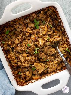 a casserole dish filled with mushrooms and parsley on the side, ready to be eaten