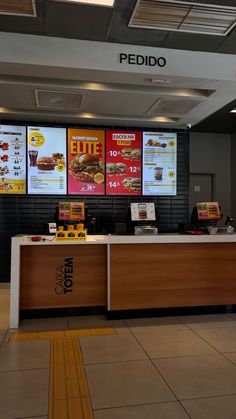 the inside of a fast food restaurant with menus on the wall