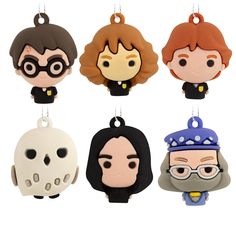 four different key chains with cartoon characters hanging from the ends of each one's strings