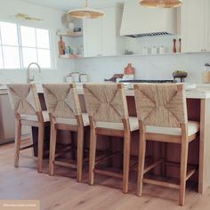 a kitchen filled with lots of wooden chairs