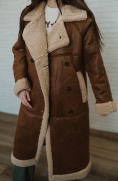 Yes, staying warm is essential - but so is looking cute! Notch rugged faux leather Teddy shearling Longline coat Side pockets 100% polyester Model is 5'3" and wearing a size small. The length of a size small is 42" with a 20" bust. Small: 2-4 Medium: 6-8 Large: 10-12 Fall Sheepskin Fur Coat With Fleece Lining, Brown Sheepskin Outerwear With Faux Fur Trim, Brown Sheepskin Outerwear With Faux Fur Lining, Fall Outerwear With Faux Fur Lining And Sheepskin, Fall Outerwear With Fleece Lining And Sheepskin, Fall Sheepskin Outerwear With Fleece Lining, Fall Sheepskin Outerwear With Faux Fur Lining, Shearling Outerwear With Faux Fur Lining, Long Coat, Long Coat With Faux Fur Lining For Cold Weather