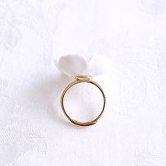 The beautiful plum blossom, who never fears frost and snow, bravely flowers in the coldest seasons, awakening spring and bringing hope. The pure and delicate petals deserve your extra love and care. Ring is made of porcelain flower; gold-plated silver ring and a small freshwater pearl. Material: Handmade porcelain plum blossom; Gold-plated silver ring; Small freshwater pearl. Gold- or silver-plated colour will fade over time. This is a normal result from long-term wear and contact with air. Howe Delicate White Proposal Ring, Delicate White Jewelry For Proposal, Delicate White Rings For Proposal, Delicate White Ring For Proposal, Minimalist White Flower Ring Gift, Adjustable White Flower Promise Ring, Delicate White Flower-shaped Ring, Delicate White Flower Ring, Delicate White Flower Shaped Ring