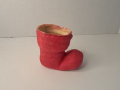 a red boot sitting on top of a white table