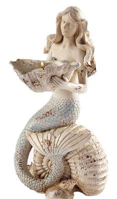 a statue of a mermaid holding a plate