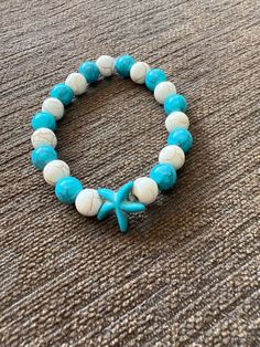 Color - Teal and Cream With Teal Starfish Charm Turquoise Starfish Beaded Bracelets, Ocean-inspired, Ocean-inspired Turquoise Starfish Beaded Bracelets, Handmade Turquoise Starfish Bracelets, Casual Beaded Bracelets With Starfish Charm, Casual Starfish Jewelry For Beach, Casual Star Jewelry For Summer, Casual Star-shaped Summer Jewelry, Casual Summer Star Shaped Jewelry, White Starfish Bracelet With Ocean-inspired Style