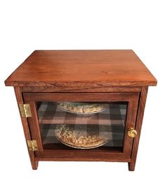 a wooden cabinet with two pies in the front and one on the bottom shelf