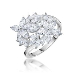 a white gold ring with three pear shaped diamonds on the shoulders and two rows of pear shaped