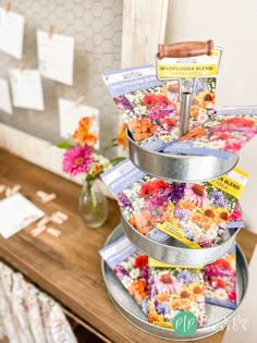 three tiered metal tray holding magazines and flowers