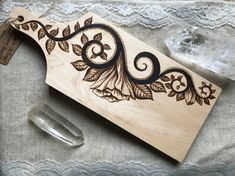 a wooden cutting board with an intricate design on it