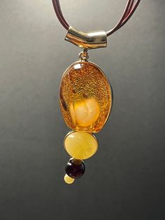 A ball of butterscotch amber looking like a fluffy rabbit tail wrapped inside a piece of 3A's super clear cognac amber formed this rare piece of jewel. The design is completed with two other butterscotch amber and one blood amber beads. Pendant height: 77.1 mm Pendant width: 26.4 mm Pendant thickness: 23.7 mm Necklace length: 450 mm with extender  Weight: 24.41 g ABOUT OUR PRODUCTS All our ambers are 100% natural, not in any way enhanced. Every item in our shop are handmade with love and happy v Luxury Amber Gold-plated Jewelry, Luxury Amber Necklaces With Gemstone Accents, Luxury Amber Oval Necklaces, Luxury Citrine Amber Necklace, Luxury Amber Citrine Necklace, Luxury Carnelian Amber Necklace, Cheap Amber Necklaces, Luxury Amber Necklaces Fine Jewelry, Luxury Amber Carved Necklace