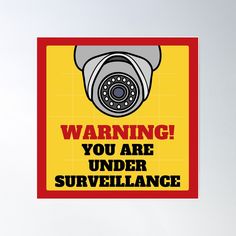 warning you are under surveillance sign with an image of a security camera on the side