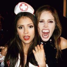 two young women dressed up as nurses posing for the camera with their mouths wide open