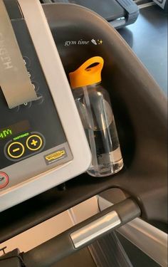 the machine is running on the treadmill and it's water bottle next to it