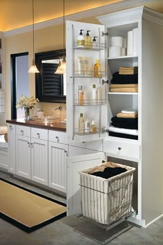 a large bathroom with white cabinets and drawers