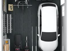 an overhead view of a white car in a garage