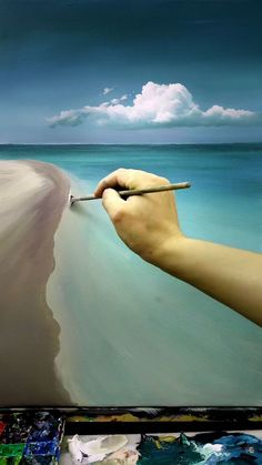 someone is painting an ocean scene with water and sand