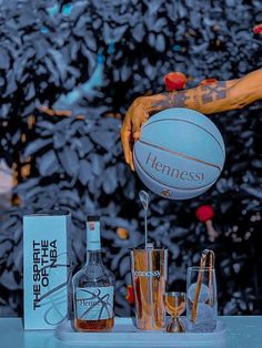 a man holding a basketball over a bar filled with liquor