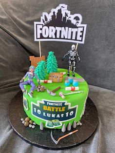 a fortnite themed birthday cake is displayed on a couch