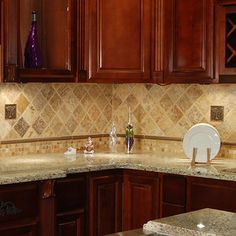 a kitchen with wooden cabinets and marble counter tops on the backsplash is shown