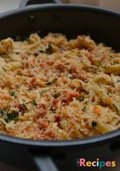 a casserole dish with cheese and vegetables in a pan on the stove top