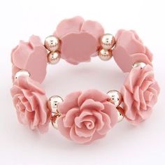 a close up of a bracelet with flowers on it