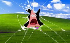 a cracked window with a cartoon character sticking out of it's face in front of a green field