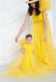 "Yellow mommy and me dress Matching Long dress Fluffy tulle dress Family outfits Mother daughter dress Matching Long Dresses Maternity dress 100% REAL PHOTOS We guarantee you high quality tailoring and fabrics! This long yellow dresses for mommy and me on one shoulder is gorgeous for photo shoots. Color#17 in our color chart - Yellow ⚠️Please note that the colors of the objects on photos may differ from real⚠️ MATERIALS: Tulle: Luxury wedding tulle \"Hayal Tulle\" .Draped, flexible, and very sof Spring Yellow Tulle Princess Dress, Yellow Tulle Summer Dress, Yellow Tulle Tutu Dress For Wedding, Yellow Tulle Tutu Dress For Spring, Spring Yellow Tulle Tutu Dress, Yellow Tutu Dress With Tulle Skirt For Spring, Spring Yellow Tutu Dress With Tulle Skirt, Summer Party Maternity Dress In Tulle, Mommy And Me Dress