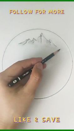 a person is drawing a mountain with a pencil