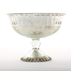 Create a stunning DIY wedding arrangement for a rustic glam look with this gorgeous silver mercury glass compote bowl. Perfect for any event centerpiece or home decorating, this pedestal is hollow to allow for extra room for stems and vase fillers. *For added stability, you may need to remove pads from bottom of pedestal* Silver 5" Tall x 7" Wide Mercury Glass Hand Wash Only Do NOT Use Harsh Chemicals Flower Bowl Centerpiece, Compote Bowl Centerpiece, Bowl Centerpiece, Pedestal Vase, Glass Centerpieces, Flower Bowl, Vase Fillers, Bowl Designs, Silver Glass